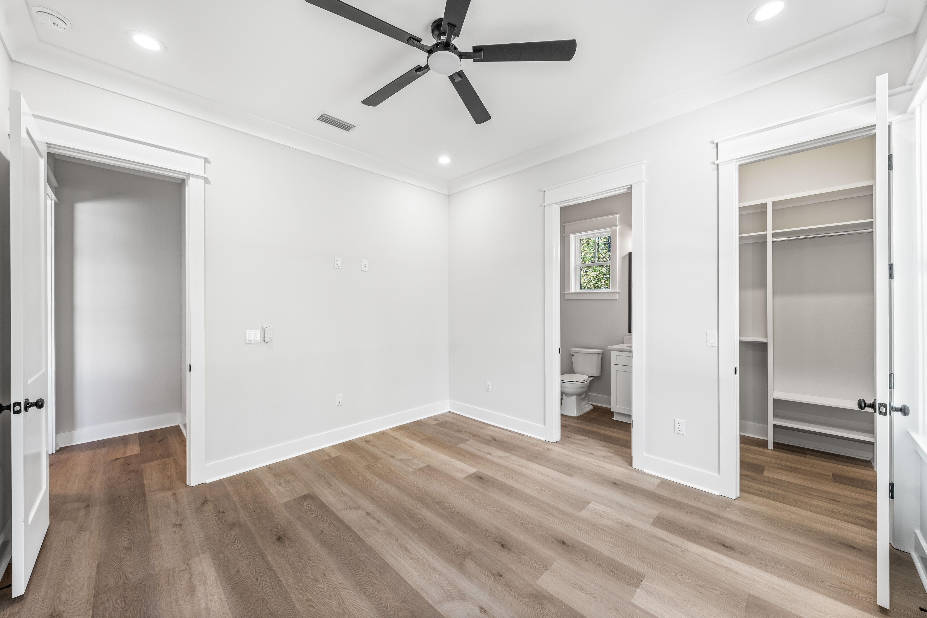 112 East Captain Fritz Way Freeport, FL 32439 - Photo 44 of 114 an empty room with wooden floor closet and windows