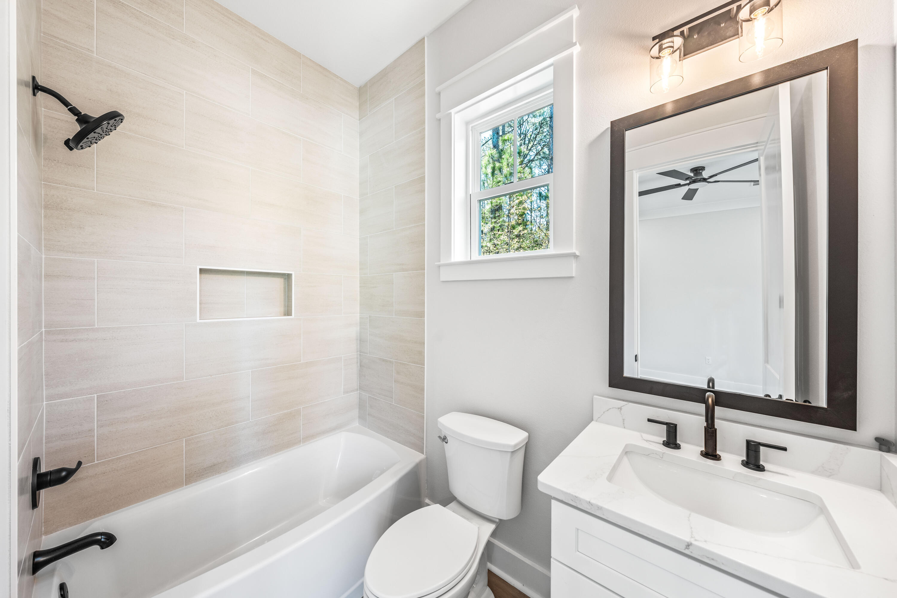 112 East Captain Fritz Way Freeport, FL 32439 - Photo 45 of 114 a bathroom with a sink toilet and shower