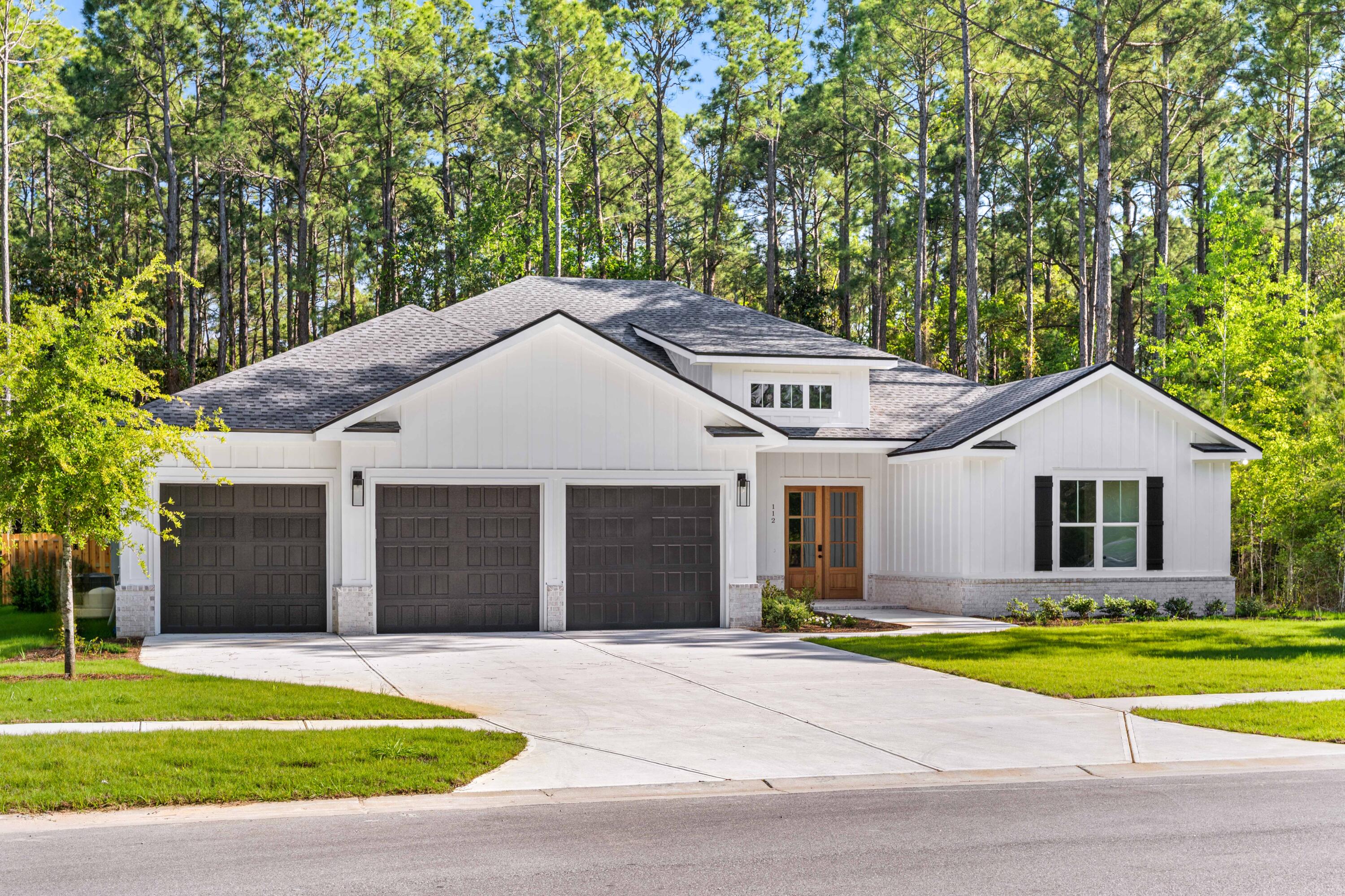 112 East Captain Fritz Way Freeport, FL 32439 - Photo 50 of 114 a front view of a house with a yard and garage