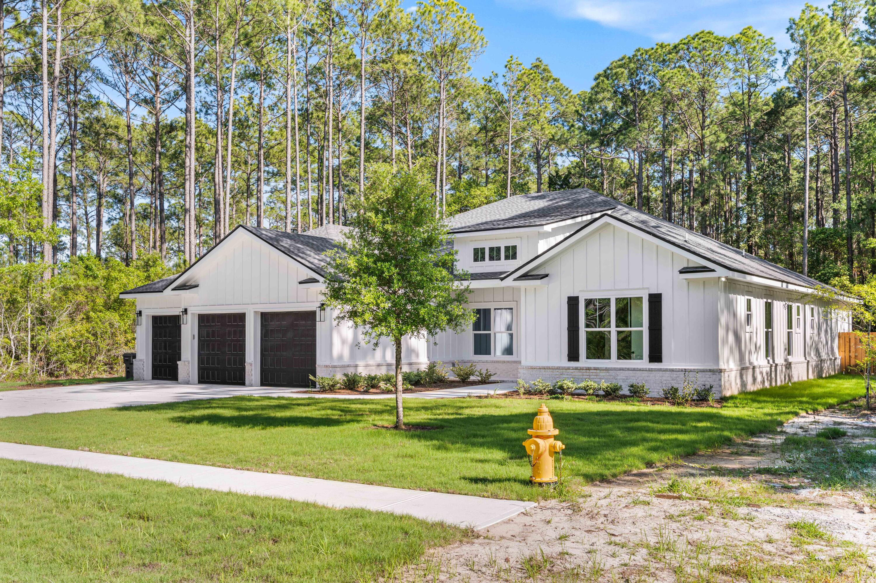 112 East Captain Fritz Way Freeport, FL 32439 - Photo 55 of 114 a front view of house with yard and green space