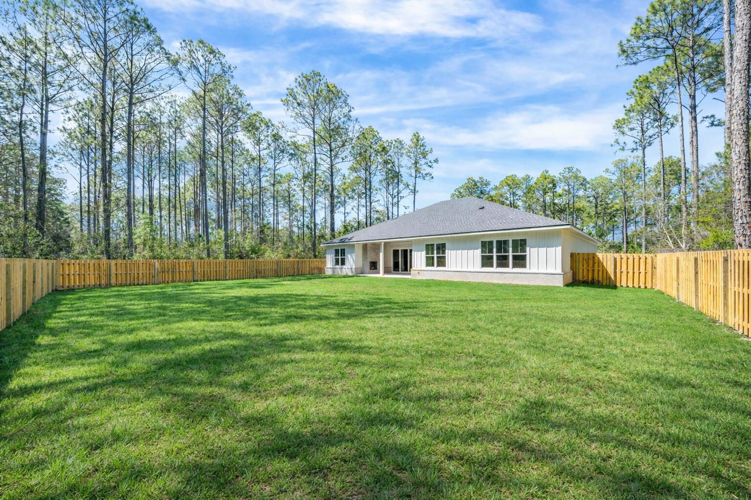 112 East Captain Fritz Way Freeport, FL 32439 - Photo 57 of 114 a front view of a house with a garden