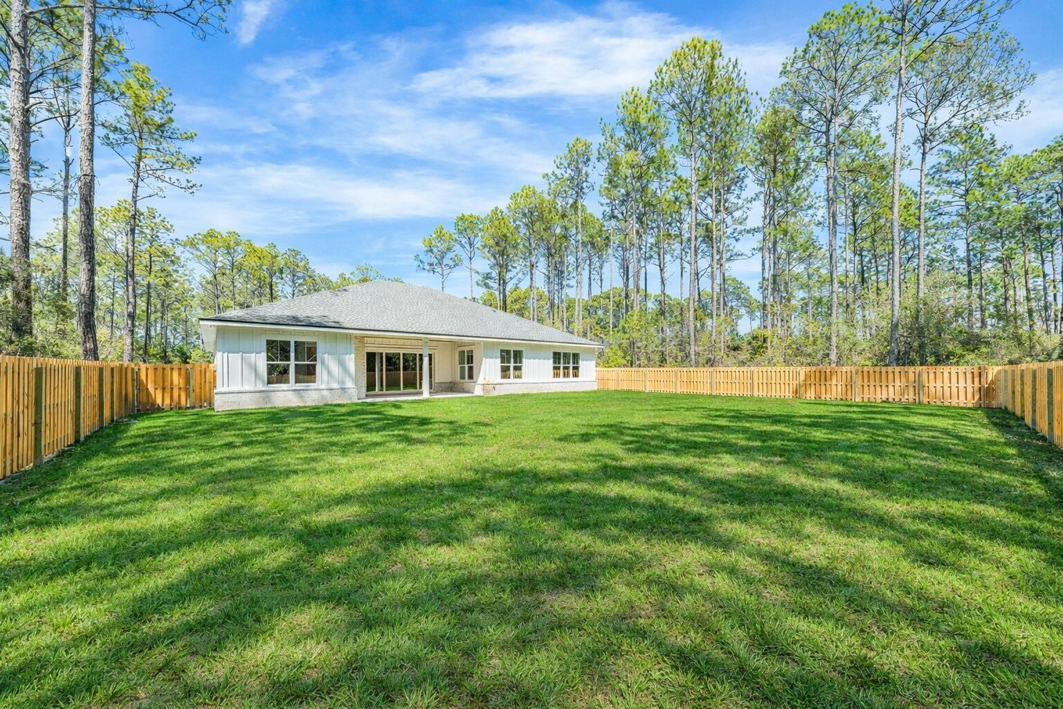112 East Captain Fritz Way Freeport, FL 32439 - Photo 58 of 114 a front view of a house with a garden