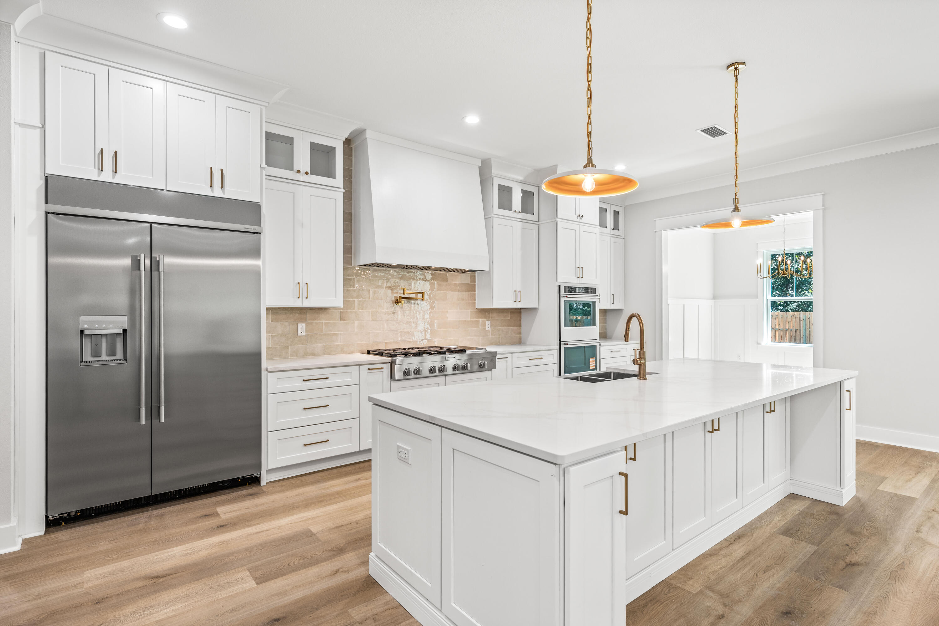 112 East Captain Fritz Way Freeport, FL 32439 - Photo 7 of 114 a kitchen with white cabinets and white appliances