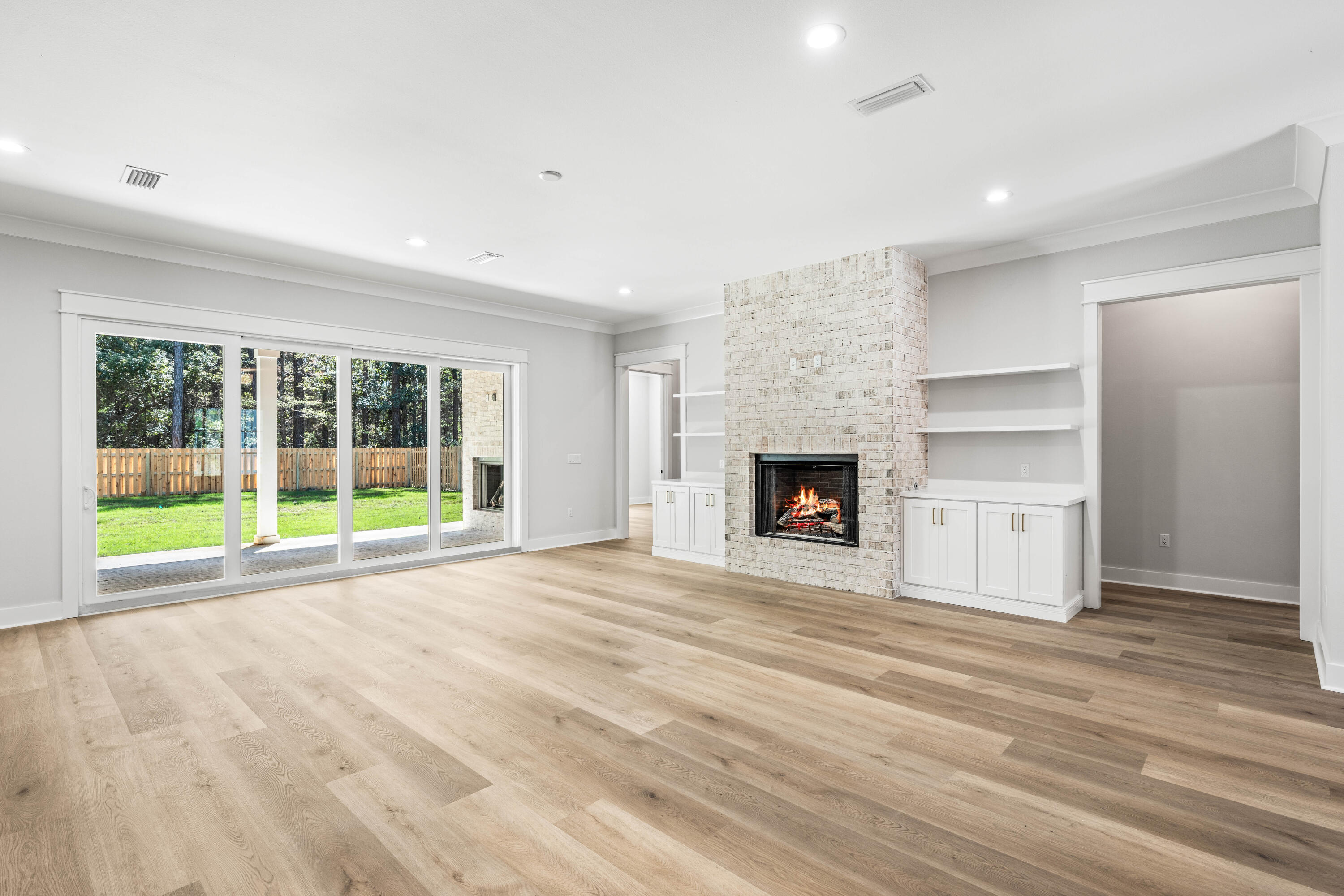 112 East Captain Fritz Way Freeport, FL 32439 - Photo 9 of 114 a view of an empty room with a window and fireplace