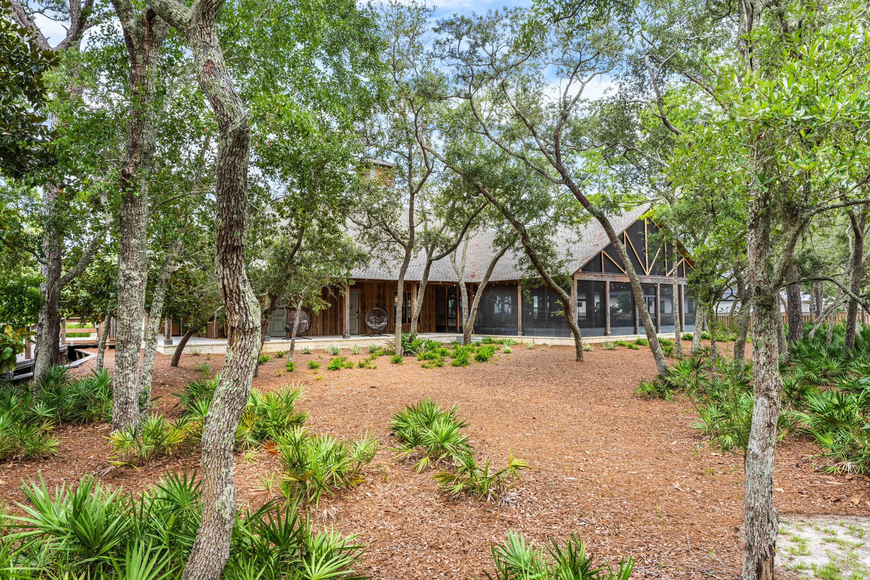 112 East Captain Fritz Way Freeport, FL 32439 - Photo 92 of 114 a front view of a house with a yard and trees