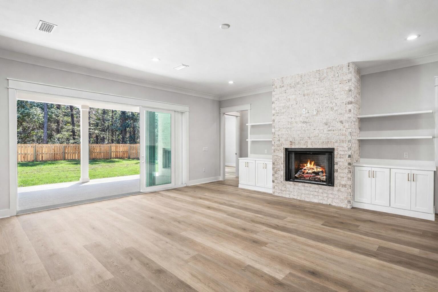 112 East Captain Fritz Way Freeport, FL 32439 - Photo 10 of 114 a view of an empty room with a fireplace and a window