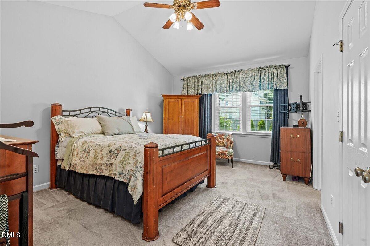 3331 Swinford Court Raleigh, NC 27604 - Photo 15 of 27 a bed sitting in a bedroom next to a window
