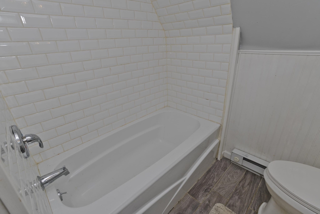 52 Gillette Circle Springfield, MA 01118 - Photo 22 of 30 a bathroom with a granite countertop toilet and a bathtub