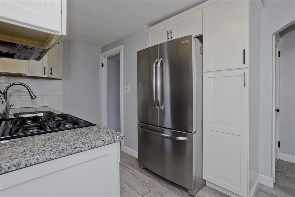52 Gillette Circle Springfield, MA 01118 - Photo 9 of 30 a kitchen with a refrigerator and a stove