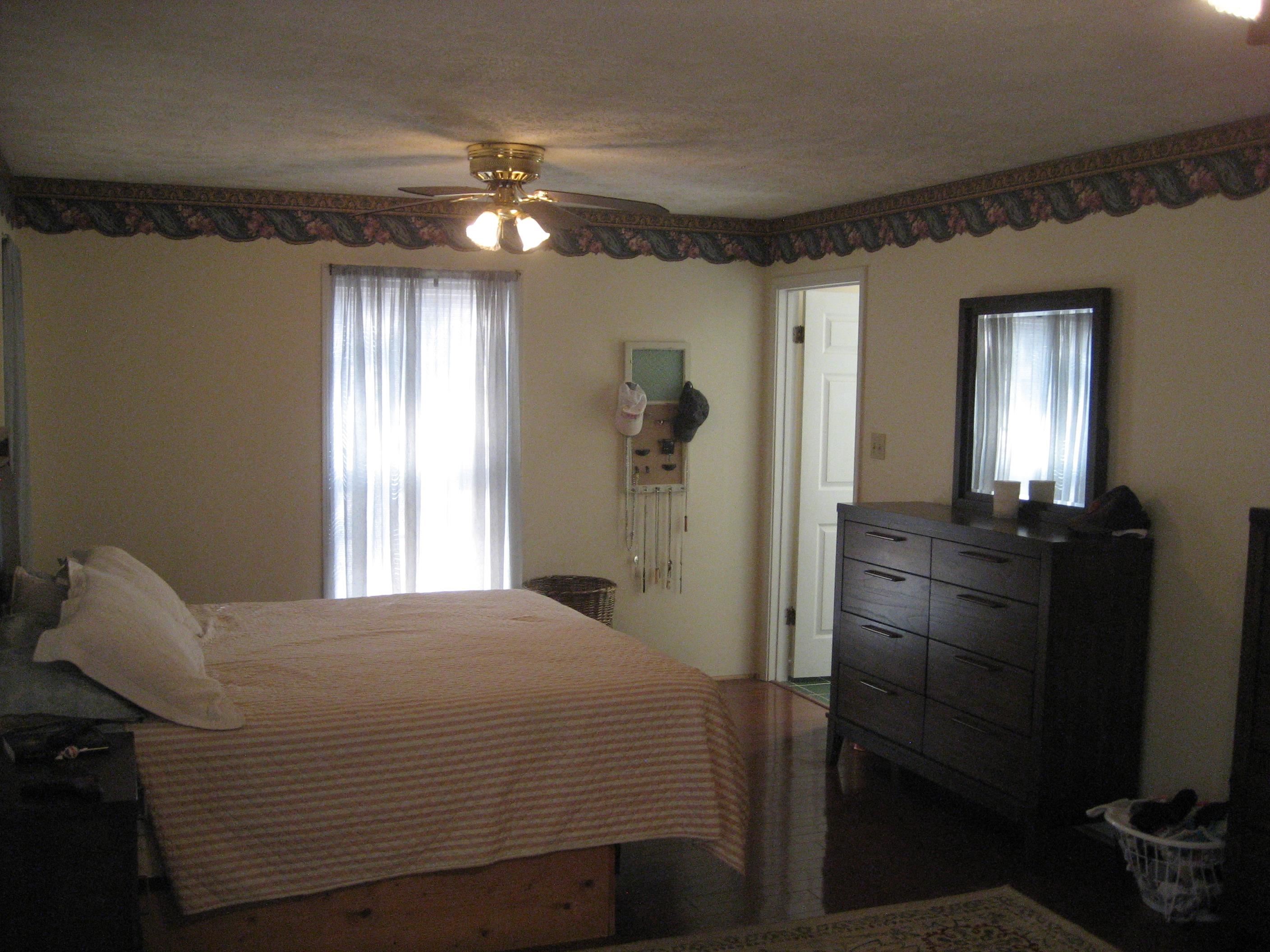 1130 Seaton Loop Adamsville, TN 38310 - Photo 13 of 24 a bedroom with a bed and a chandelier