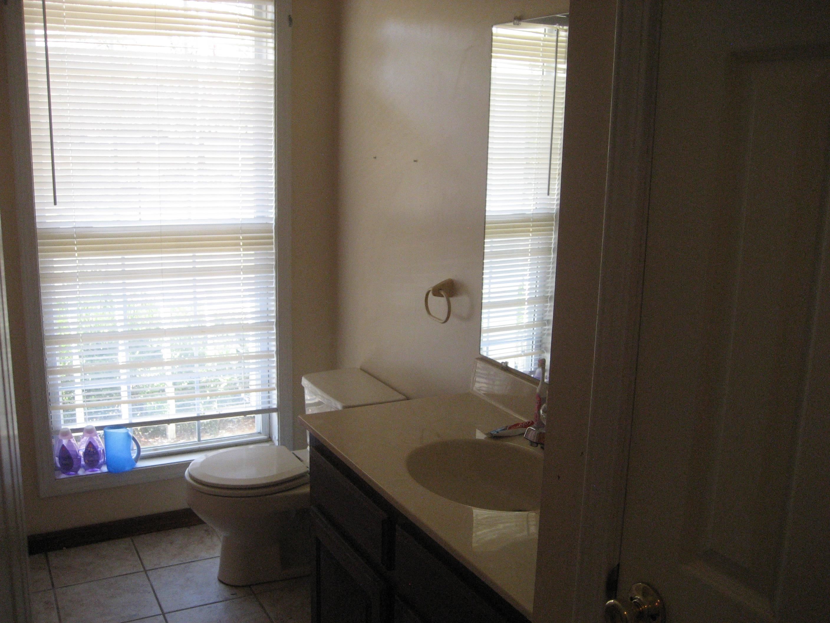 1130 Seaton Loop Adamsville, TN 38310 - Photo 14 of 24 a bathroom with a toilet sink and window