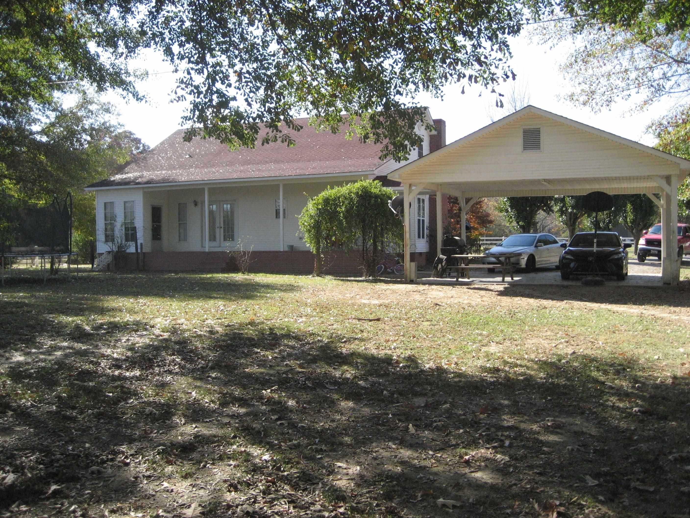 1130 Seaton Loop Adamsville, TN 38310 - Photo 20 of 24 a front view of a house with a yard and porch