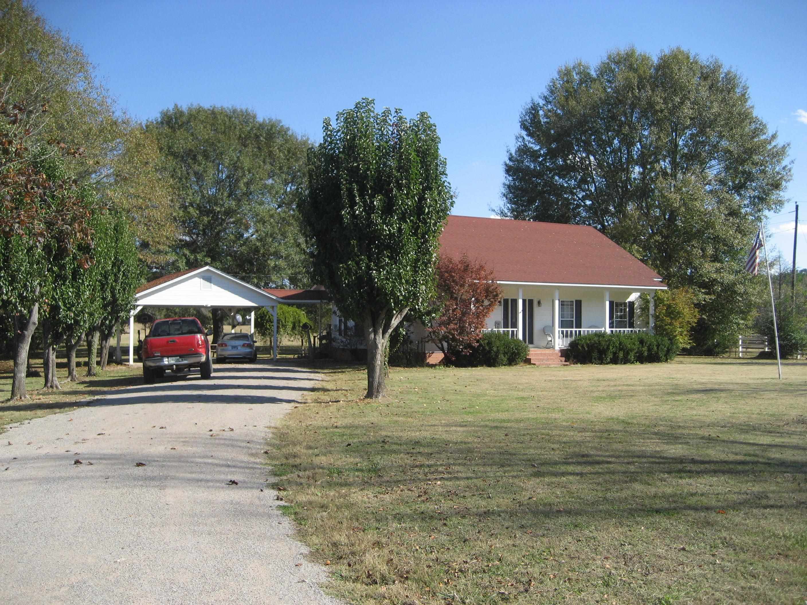 1130 Seaton Loop Adamsville, TN 38310 - Photo 2 of 24 a front view of a house with a yard