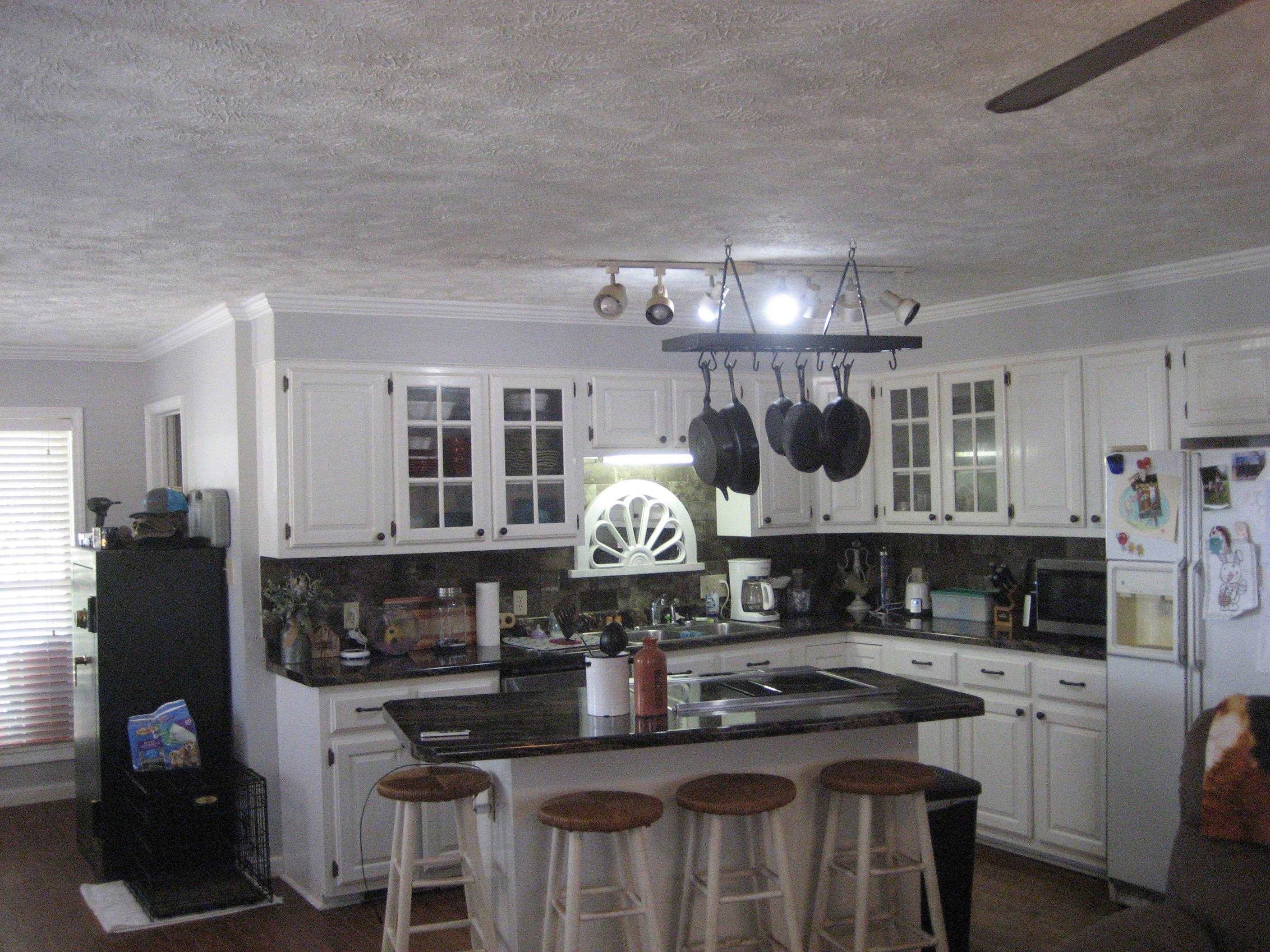 1130 Seaton Loop Adamsville, TN 38310 - Photo 4 of 24 a kitchen with stainless steel appliances granite countertop a stove and cabinets