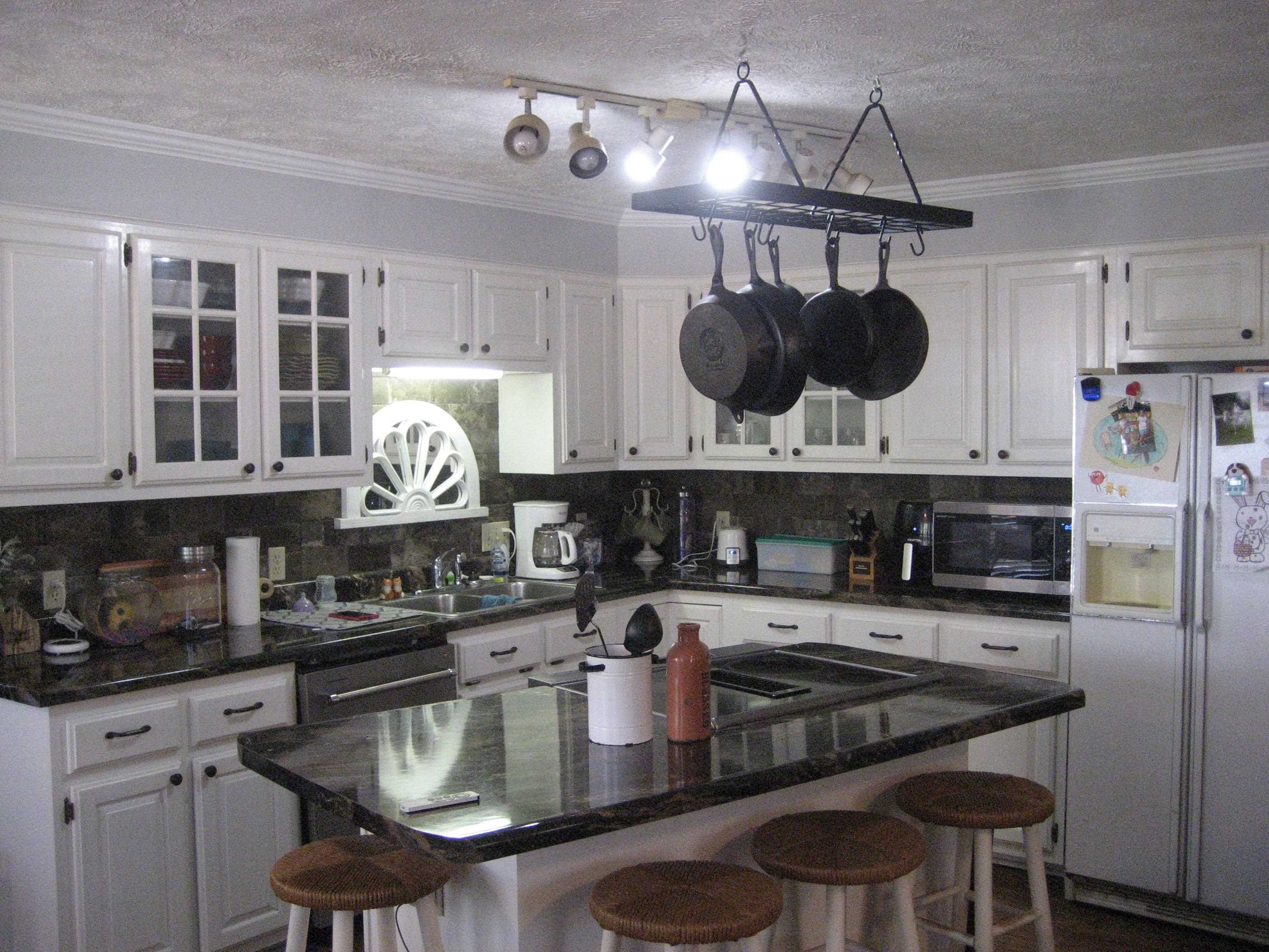 1130 Seaton Loop Adamsville, TN 38310 - Photo 6 of 24 a kitchen with a stove a microwave and cabinets