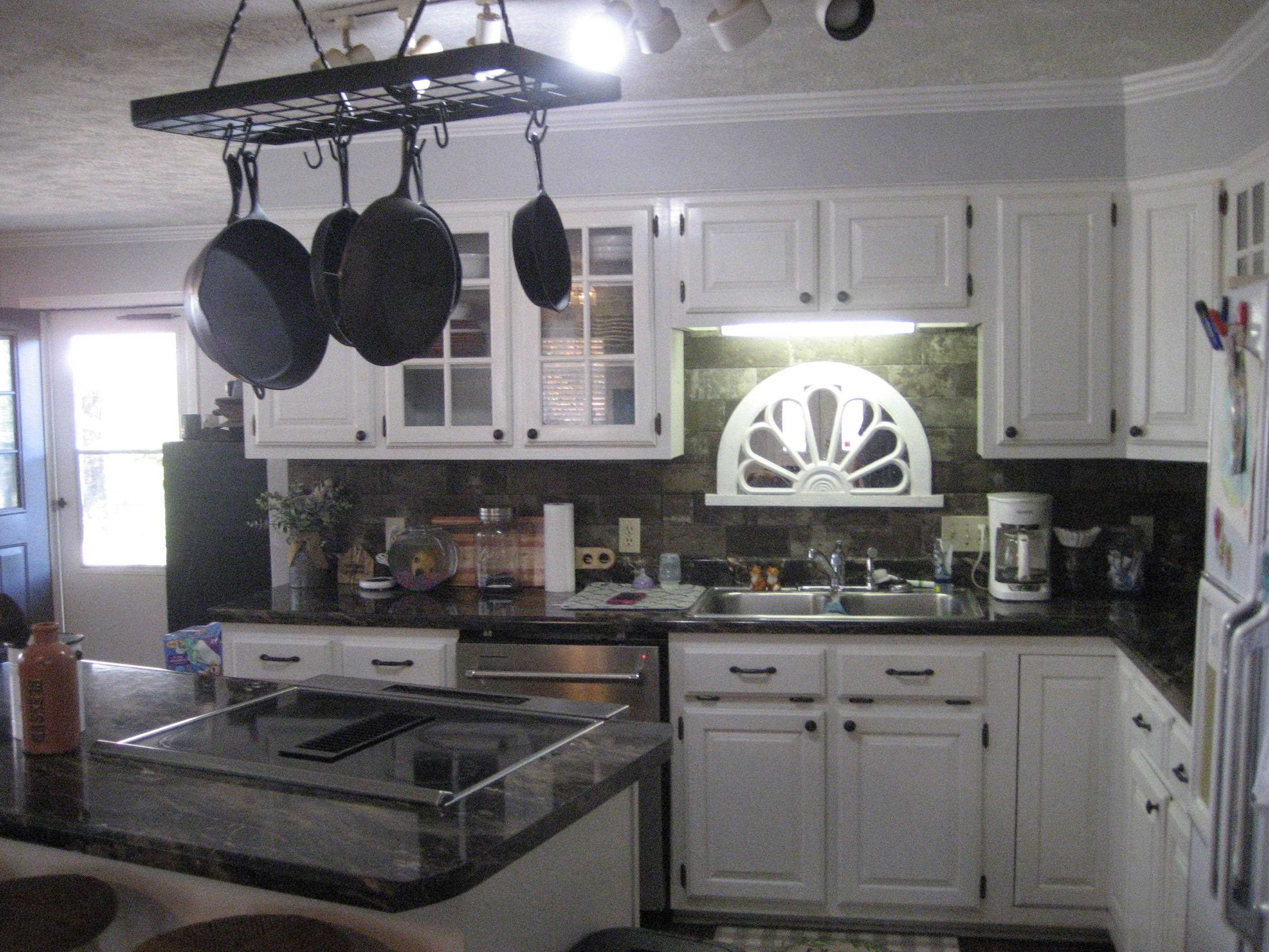 1130 Seaton Loop Adamsville, TN 38310 - Photo 7 of 24 a kitchen with stainless steel appliances granite countertop a sink and a stove