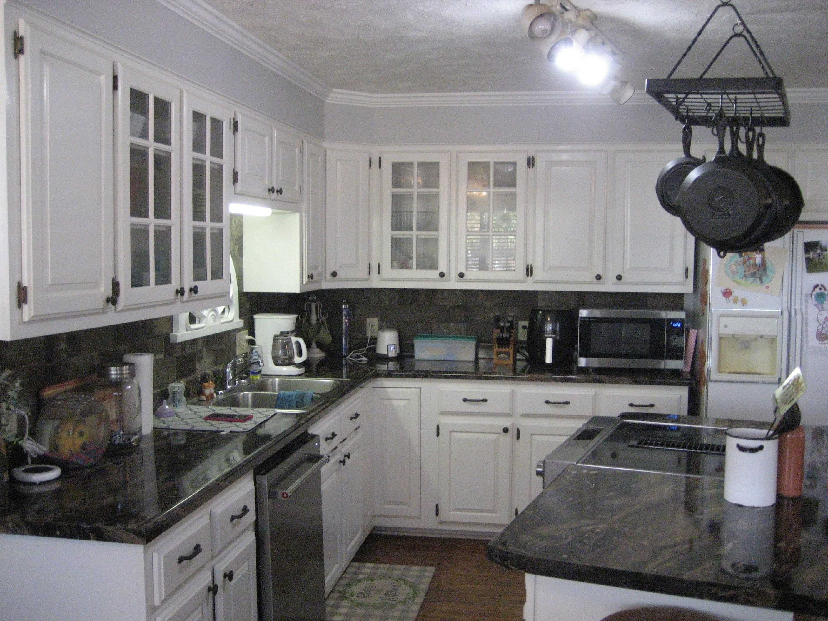 1130 Seaton Loop Adamsville, TN 38310 - Photo 8 of 24 a kitchen with stainless steel appliances granite countertop a sink dishwasher stove and cabinets