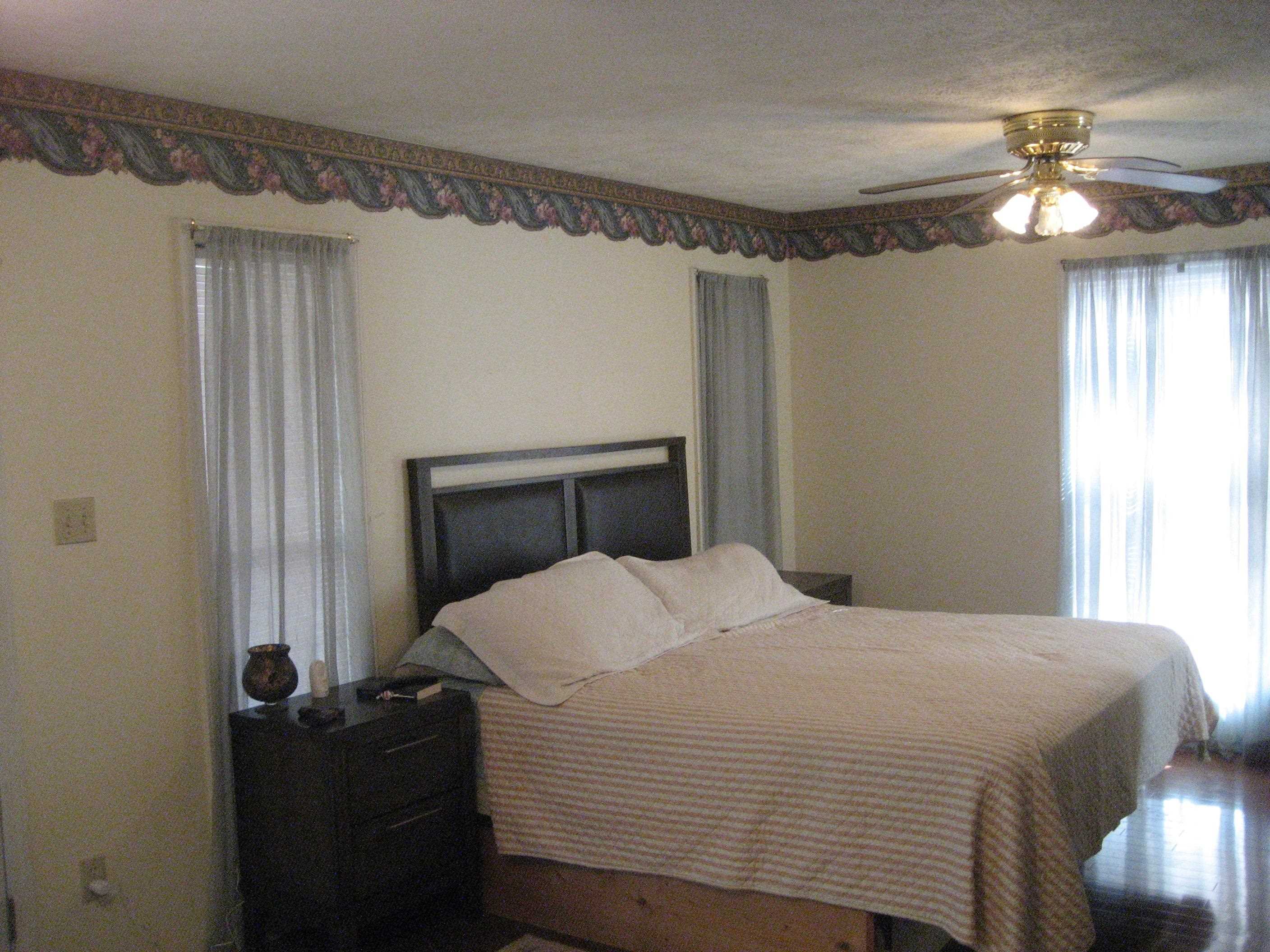 1130 Seaton Loop Adamsville, TN 38310 - Photo 10 of 24 a bedroom with a bed and a chandelier