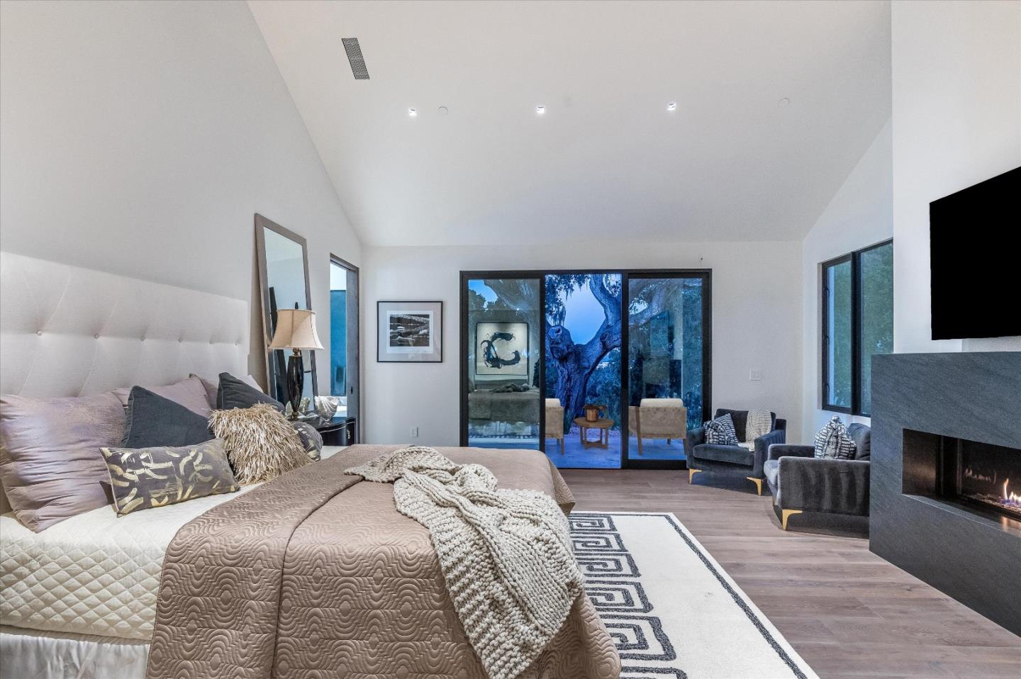 8140 Manjares Road Monterey, CA 93940 - Photo 12 of 20 a bedroom with a large bed a flat tv screen and dresser