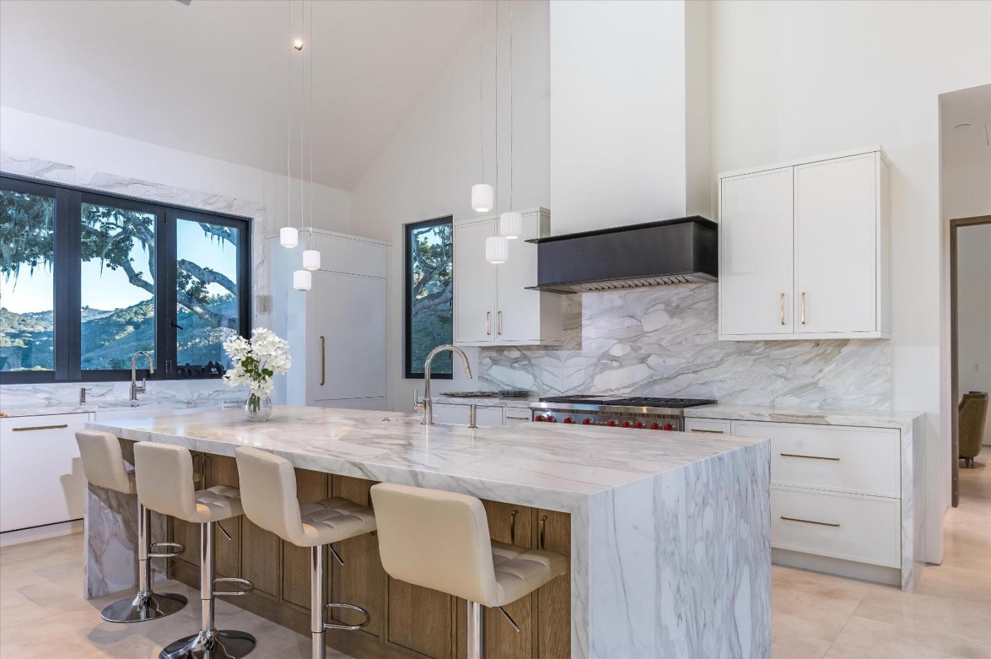 8140 Manjares Road Monterey, CA 93940 - Photo 10 of 20 a kitchen with stainless steel appliances granite countertop a stove a sink dishwasher and white cabinets with wooden floor