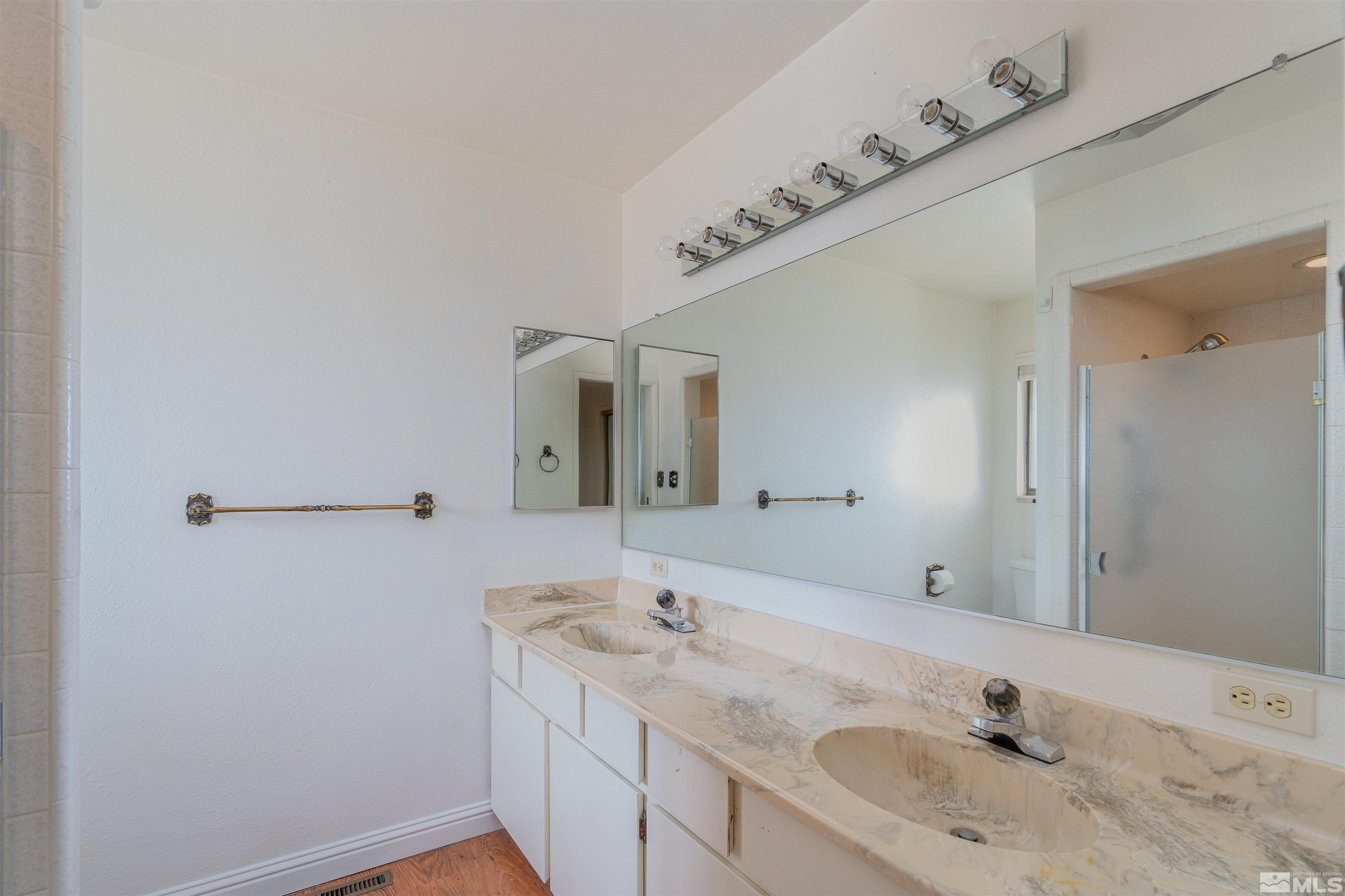 5705 Blue Hills Drive Reno, NV 89502 - Photo 17 of 29 a bathroom with a granite countertop sink and a mirror