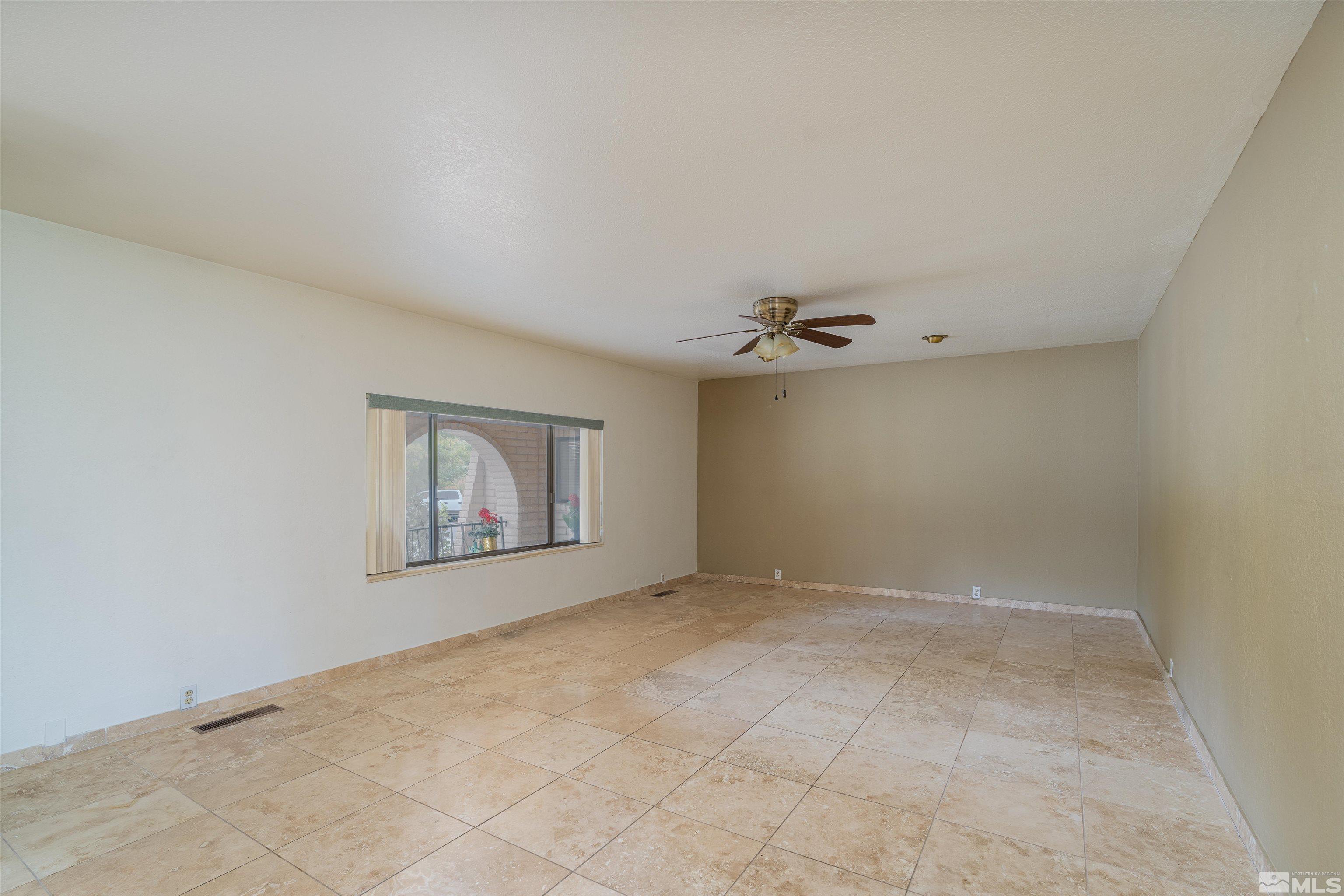 5705 Blue Hills Drive Reno, NV 89502 - Photo 18 of 29 an empty room with a ceiling fan and window