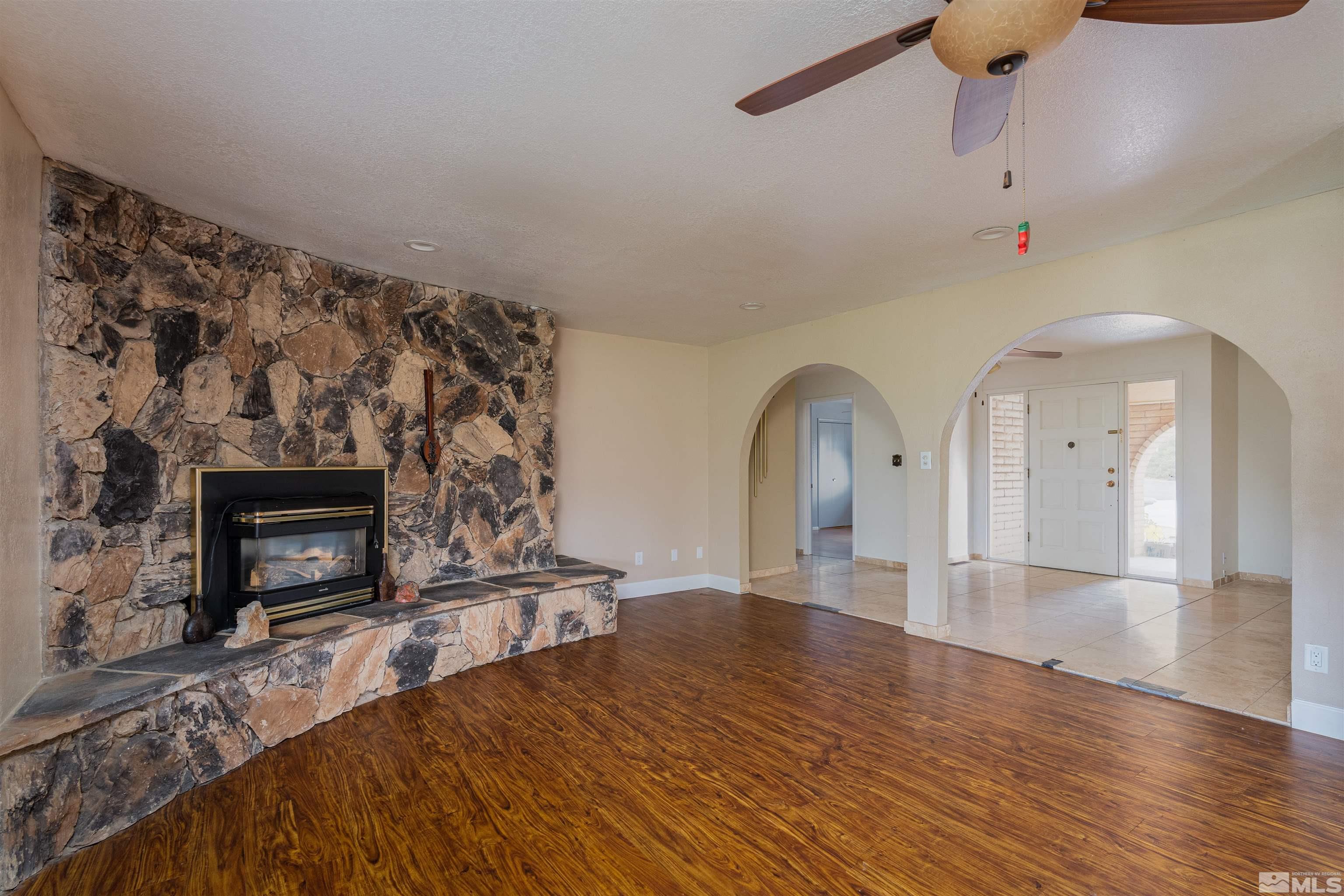 5705 Blue Hills Drive Reno, NV 89502 - Photo 6 of 29 a view of empty room with fireplace and wooden floor