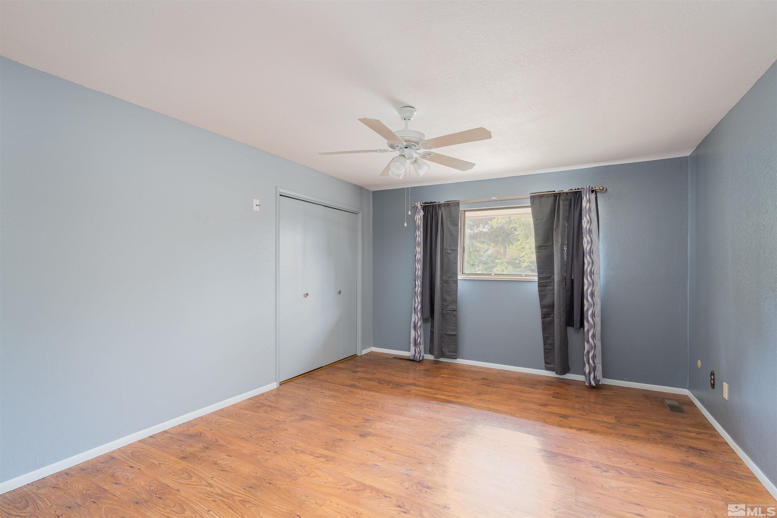 5705 Blue Hills Drive Reno, NV 89502 - Photo 8 of 29 a view of a big room with closet and a ceiling fan