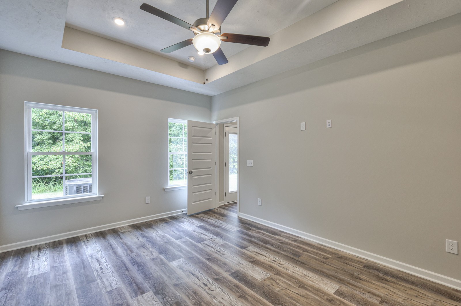 113 Creek Wood Road Manchester, TN 37355 - Photo 19 of 37 an empty room with wooden floor chandelier fan and windows