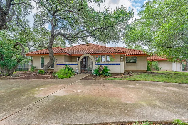 a front view of a house with a yard and a garage
