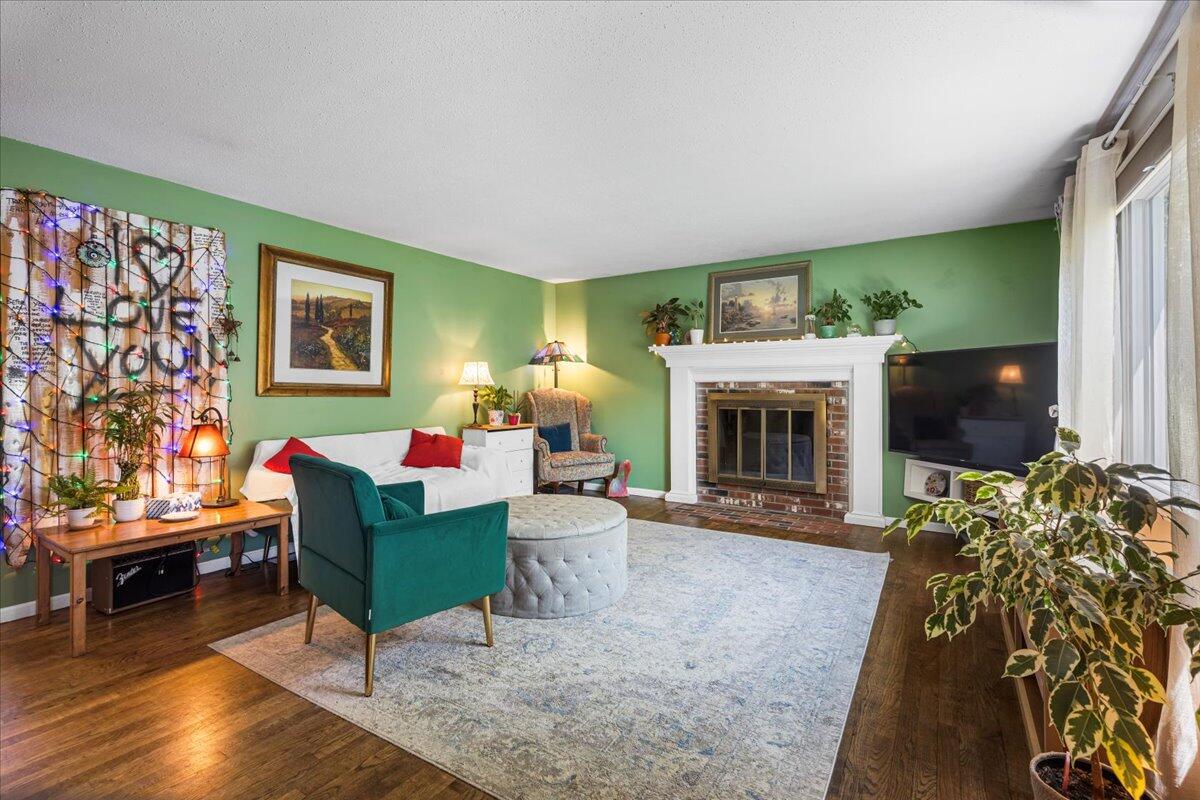 48 Valley Brook Road Centerville, MA 02632 - Photo 11 of 34 a living room with furniture a flat screen tv and a fireplace