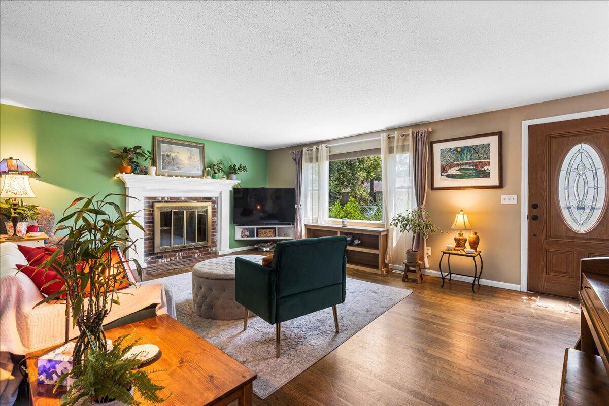 48 Valley Brook Road Centerville, MA 02632 - Photo 12 of 34 a living room with furniture a window and a fireplace