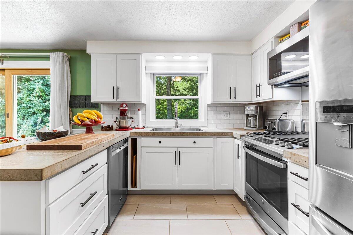 48 Valley Brook Road Centerville, MA 02632 - Photo 18 of 34 a kitchen with a stove sink and cabinets