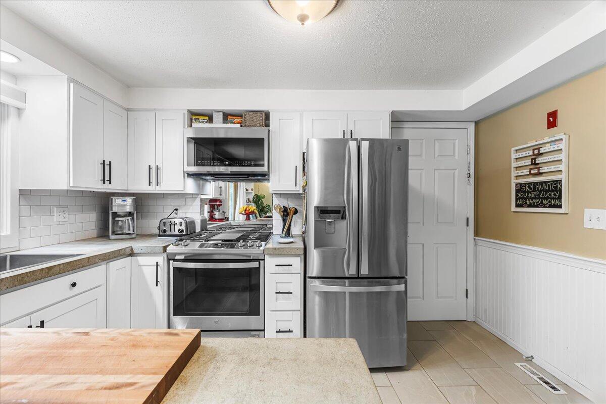 48 Valley Brook Road Centerville, MA 02632 - Photo 19 of 34 a kitchen with stainless steel appliances granite countertop a refrigerator stove and sink