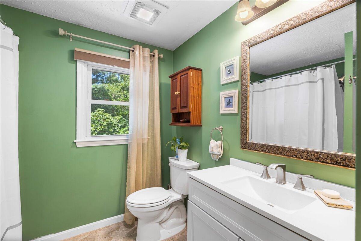48 Valley Brook Road Centerville, MA 02632 - Photo 23 of 34 a bathroom with a toilet sink vanity and mirror