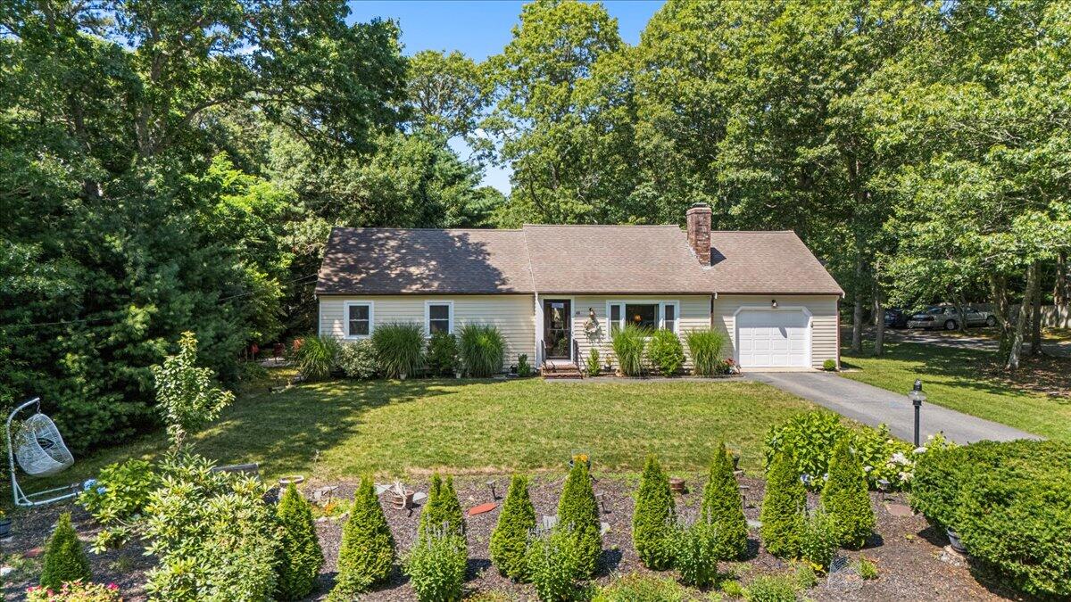 48 Valley Brook Road Centerville, MA 02632 - Photo 5 of 34 a front view of a house with a yard