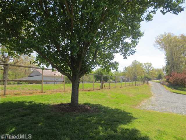 4600 Grubbs Road Walkertown, NC 27051 - Photo 2 of 16 Exterior Front. LONG WONDERFUL DRIVEWAY WITH TONS OF PARKING, 3 CAR GARAGE WITH NEW ROOF, ONE SIDE OF GARAGE HAS A GARAGE DOOR OPENER, ONCE YOU ENTER THE GATE YOU ARE ON YOUR OWN LAND. MATURING FRUIT AND NUT TREES GALORE- WOW!!