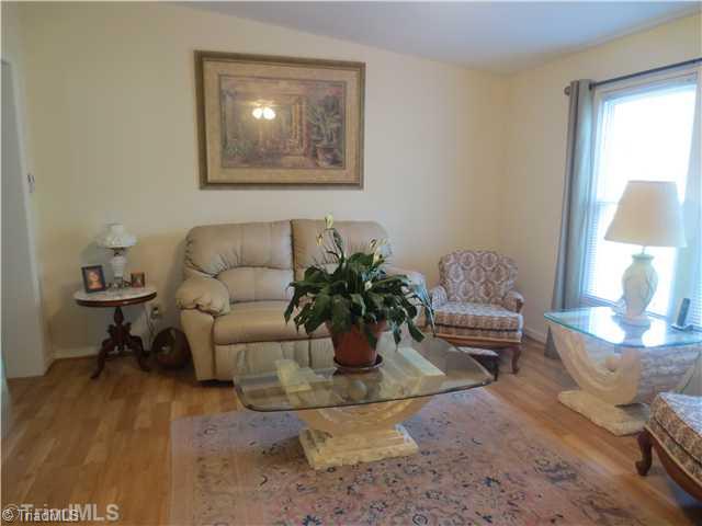 4600 Grubbs Road Walkertown, NC 27051 - Photo 3 of 16 Living Room. LIVING ROOM HAS BEAUTIFUL LAMINATE FLOORING. ENTER THE COVERED PORCH. ALSO THERE IS A BACKUP PROPANE HEAT AND AC- YOU ARE ALL SET!