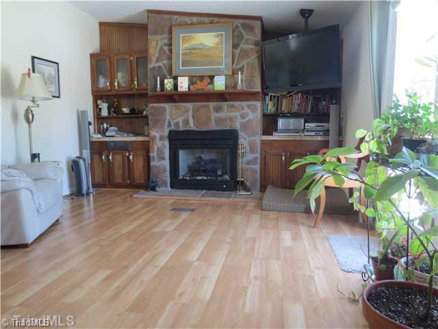 4600 Grubbs Road Walkertown, NC 27051 - Photo 7 of 16 Den/Family/Great Room. BEAUTIFUL DEN HAS FRENCH DOORS LEADING TO DECK WHICH IS FRESHLY PAINTED AND HAS AMAZING VIEWS OF MEADOWS AND ALL THE BEAUTY OF THE ACREAGE. GAS FIREPLACE AND LAMINATE FLOORS GIVE THIS DEN THE "COZY" FEEL YOU ARE LOOKING FOR!