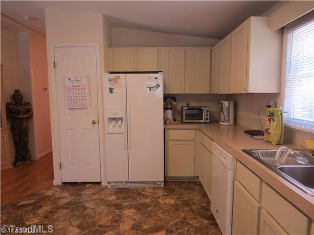 4600 Grubbs Road Walkertown, NC 27051 - Photo 9 of 16 Kitchen. NICE SUNNY KITCHEN LEADS TO LAUNDRY ROOM AND HALF BATH WITH ANOTHER DECK ON THE SIDE OF THE HOUSE WITH THE GARAGE