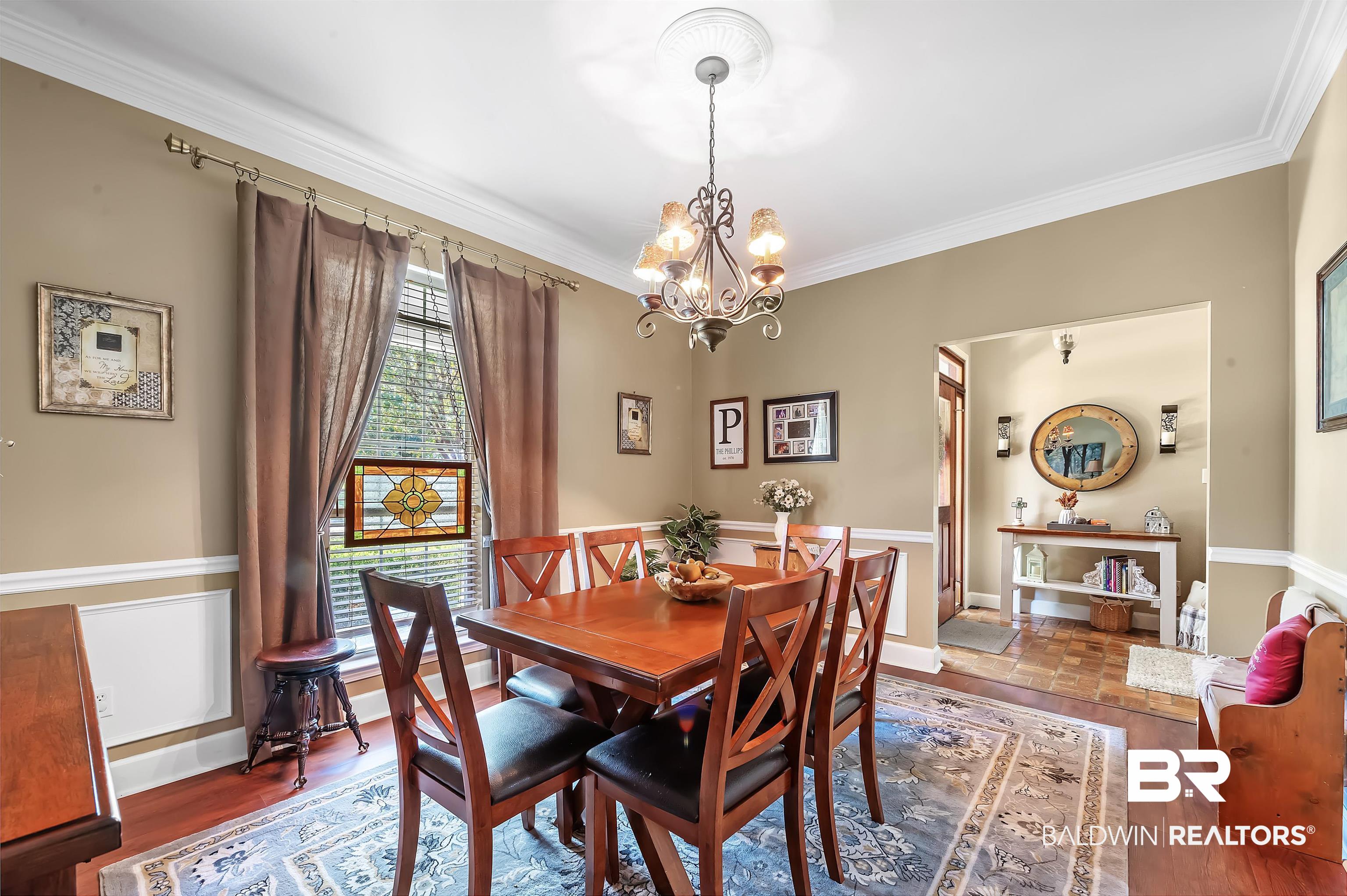 9901 Glover Court Fairhope, AL 36532 - Photo 9 of 52 Dining room with ornamental molding, dark hardwood / wood-style floors, and a chandelier