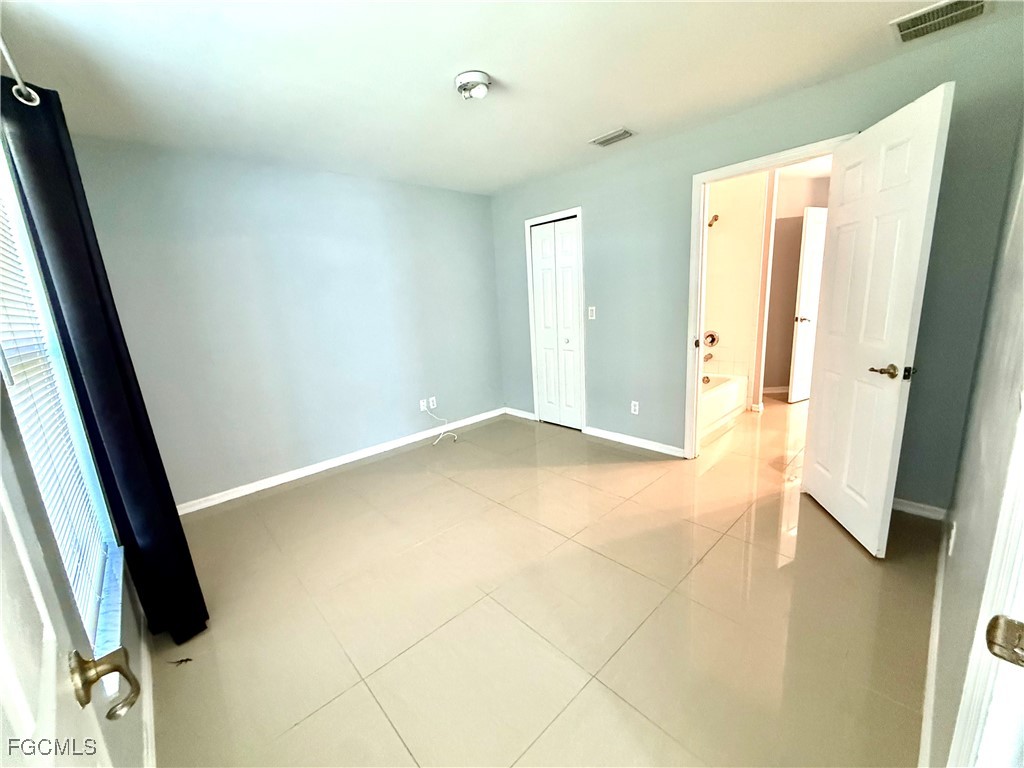 2911 40th Street Southwest Lehigh Acres, FL 33976 - Photo 13 of 22 a view of bathroom with a sink and mirror
