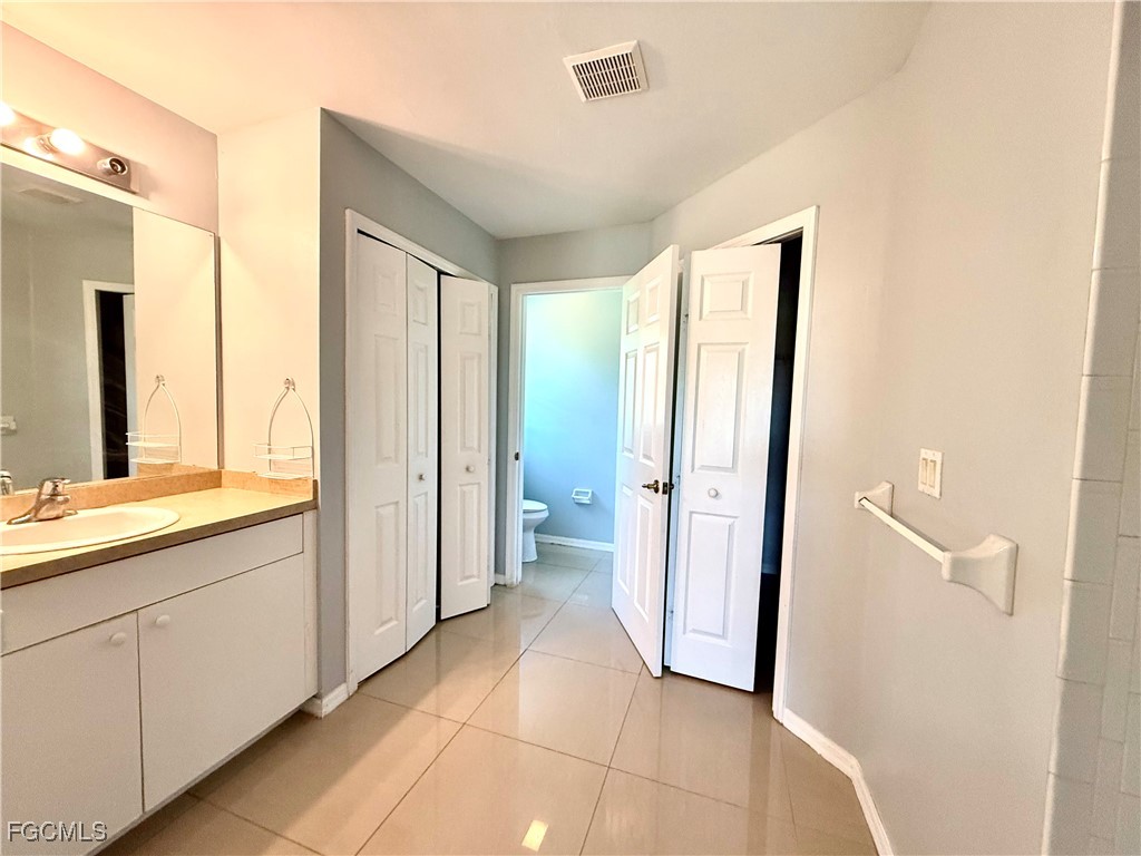 2911 40th Street Southwest Lehigh Acres, FL 33976 - Photo 15 of 22 a view of a kitchen with a sink and a large mirror