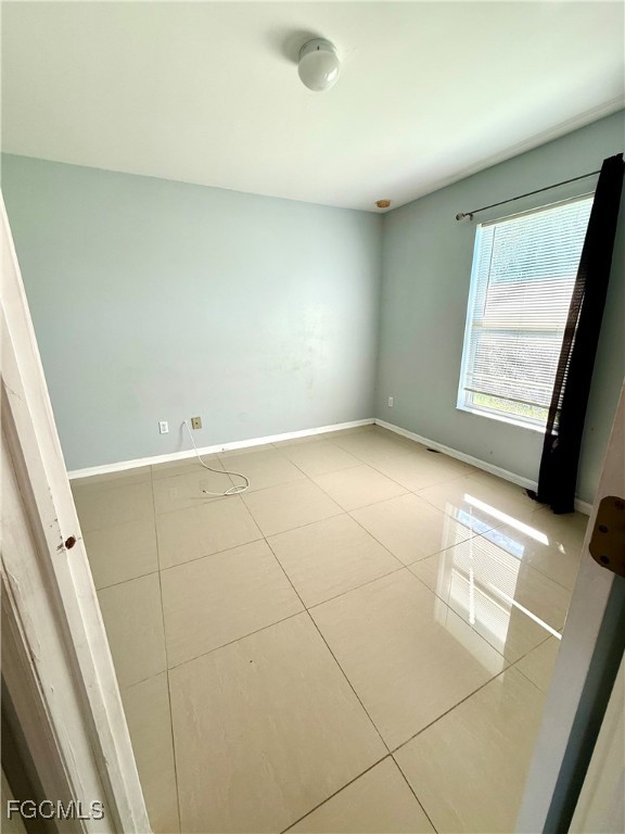 2911 40th Street Southwest Lehigh Acres, FL 33976 - Photo 16 of 22 a view of an empty room and a window
