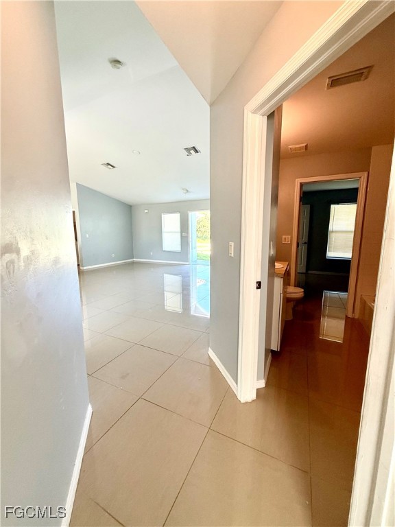 2911 40th Street Southwest Lehigh Acres, FL 33976 - Photo 20 of 22 a view of a hallway with wooden floor and a bathroom