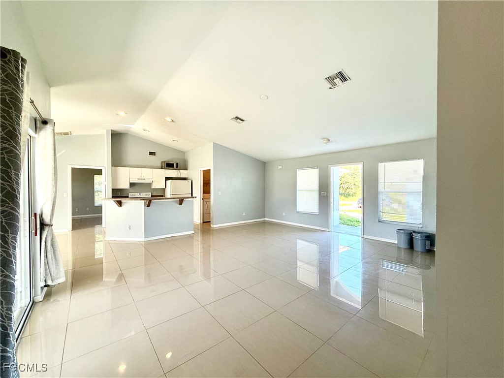 2911 40th Street Southwest Lehigh Acres, FL 33976 - Photo 3 of 22 a view of a kitchen with furniture and an empty room