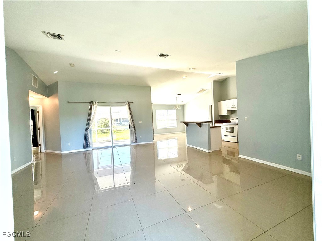2911 40th Street Southwest Lehigh Acres, FL 33976 - Photo 7 of 22 a view of a kitchen with furniture and an empty room