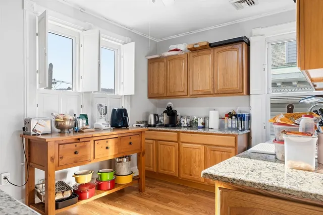 a kitchen with stainless steel appliances granite countertop a sink stove and cabinets