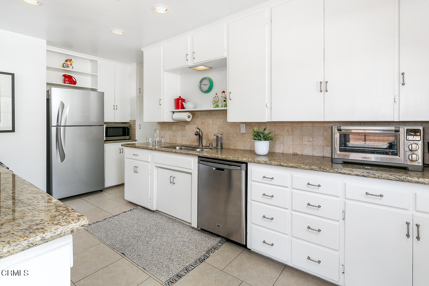 2375 East Woodlyn Road Pasadena, CA 91104 - Photo 14 of 33 a kitchen with a refrigerator sink and cabinets