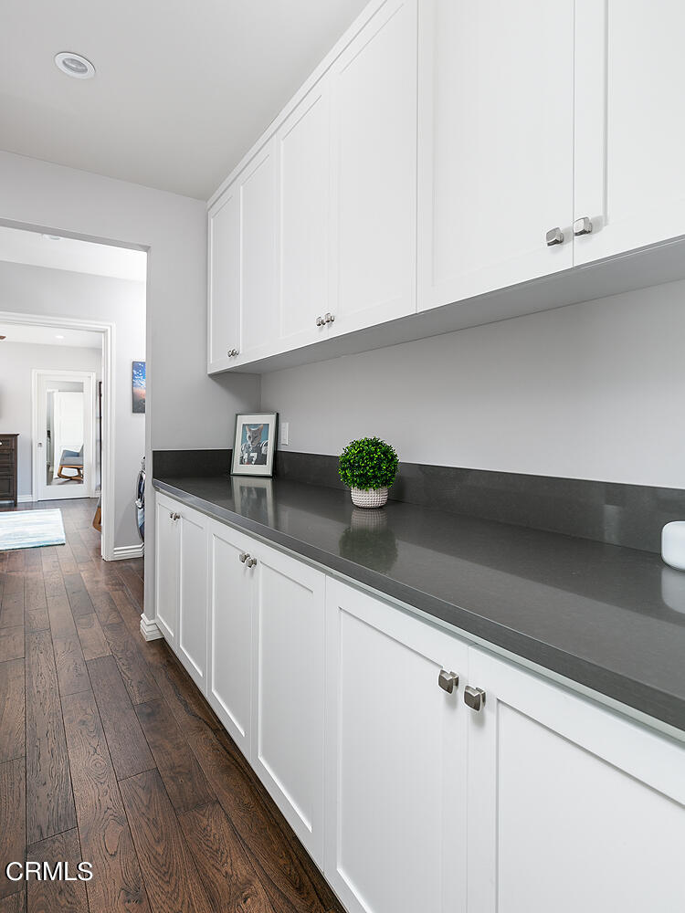 2375 East Woodlyn Road Pasadena, CA 91104 - Photo 17 of 33 a kitchen with granite countertop white cabinets and a wooden floor